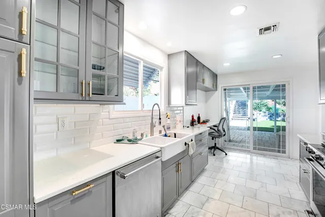 a kitchen with a sink and cabinets