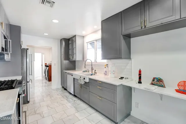 a kitchen with a sink cabinets and appliances