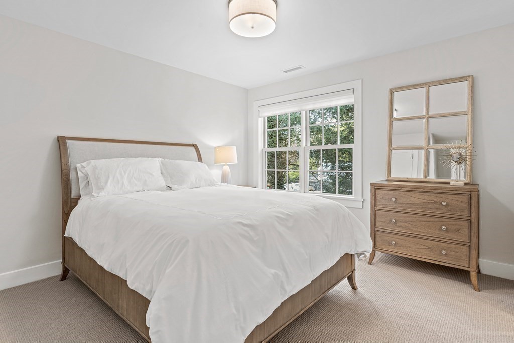 19 River Glen Road Wellesley, MA 02481 - Photo 17 of 31 a large bed sitting in a bedroom next to a window