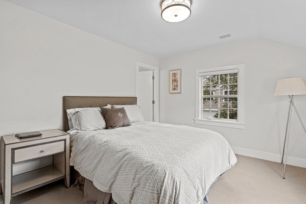 19 River Glen Road Wellesley, MA 02481 - Photo 19 of 31 a bedroom with a bed and a window