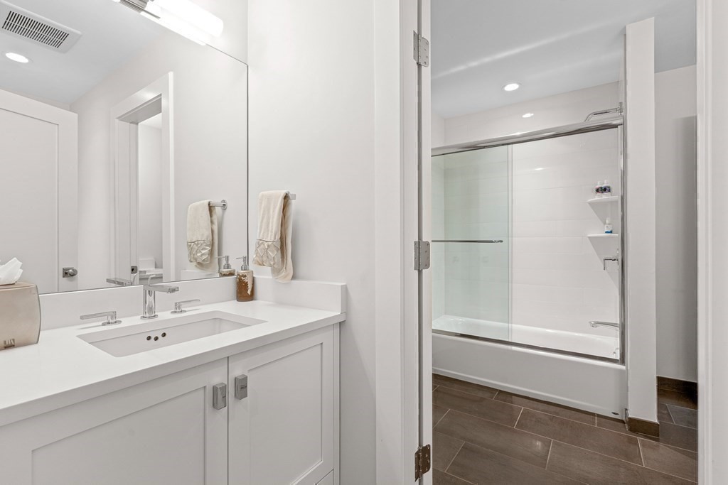 19 River Glen Road Wellesley, MA 02481 - Photo 20 of 31 a bathroom with a double vanity sink a mirror and a shower