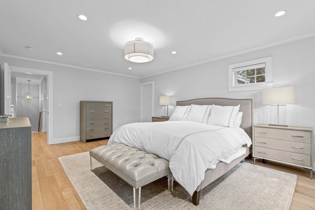 19 River Glen Road Wellesley, MA 02481 - Photo 23 of 31 a spacious bedroom with a bed and a couch