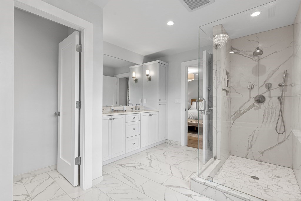 19 River Glen Road Wellesley, MA 02481 - Photo 26 of 31 a bathroom with a shower sink and mirror