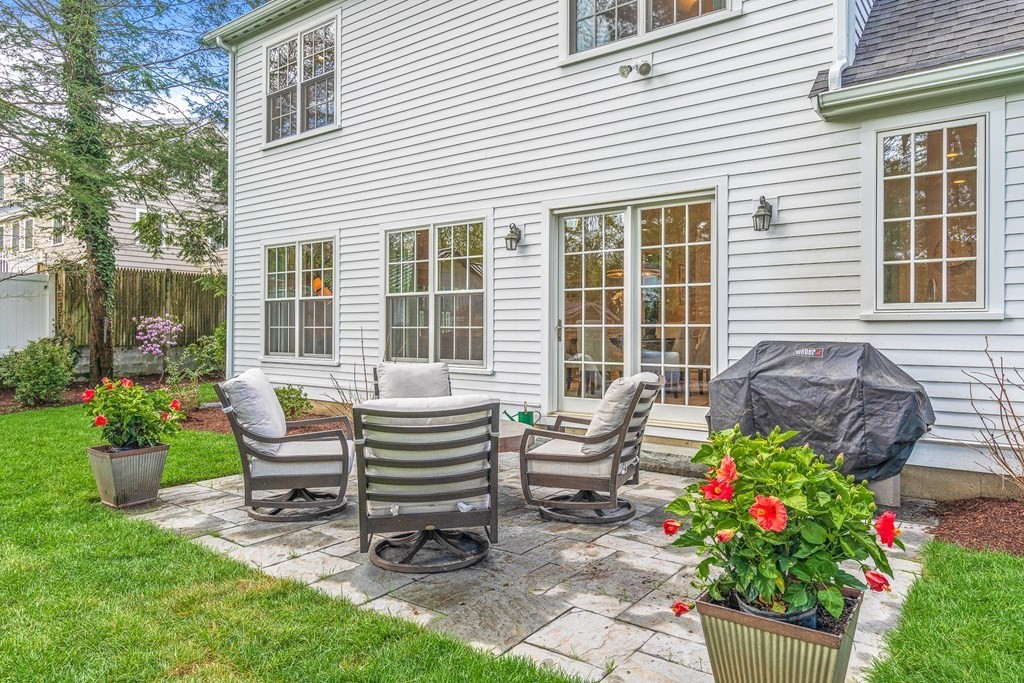 19 River Glen Road Wellesley, MA 02481 - Photo 28 of 31 a view of a house with chair and a table in the patio