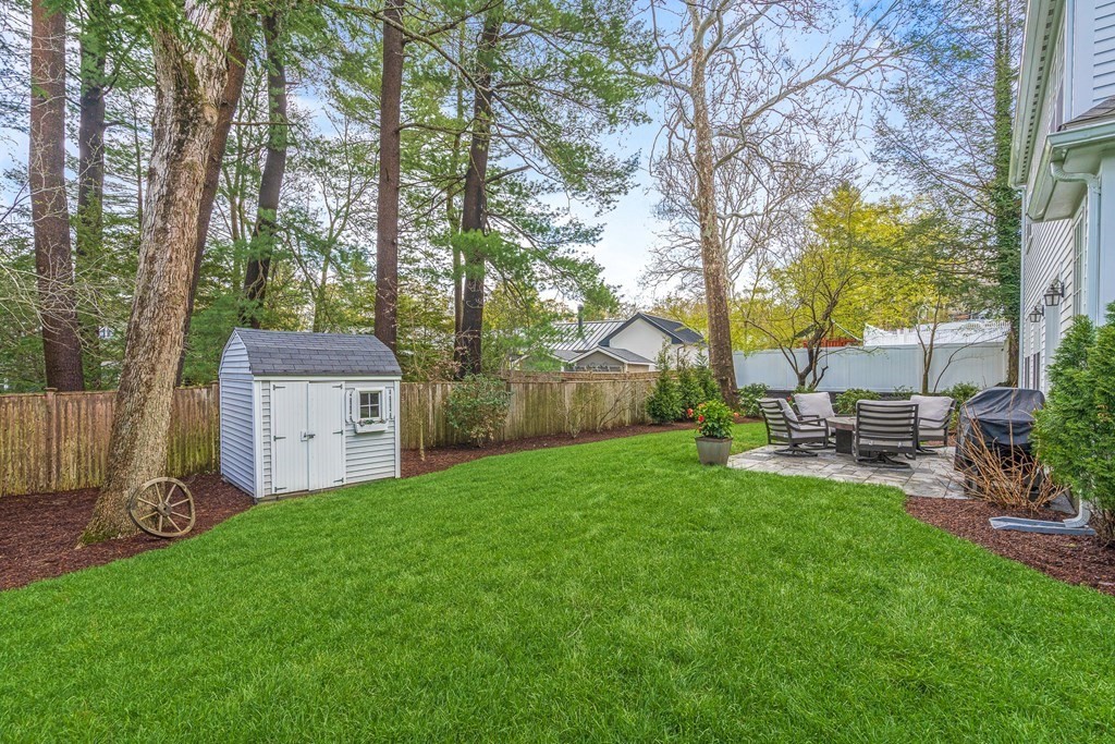 19 River Glen Road Wellesley, MA 02481 - Photo 29 of 31 a view of a chair and table in backyard of the house