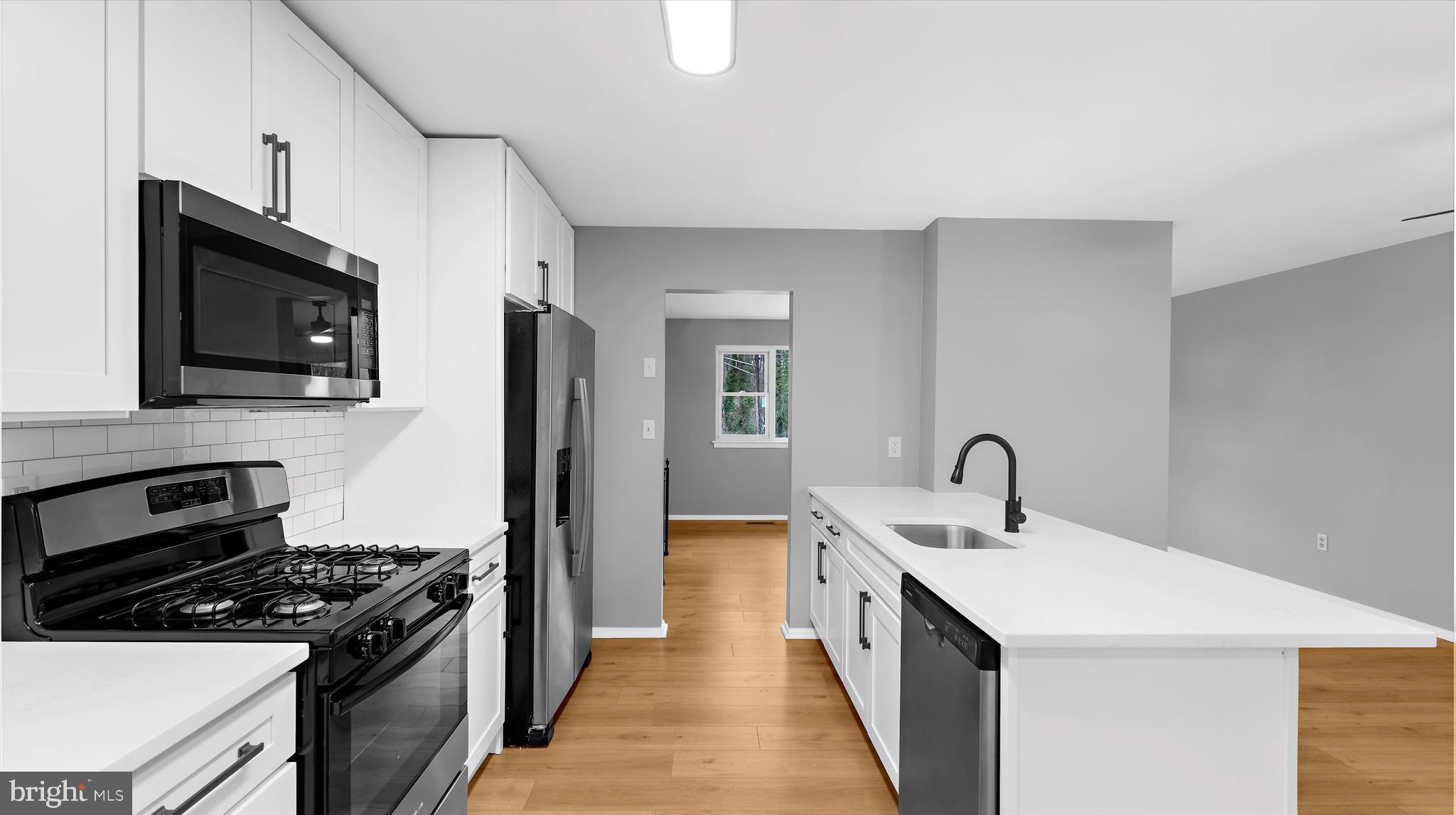 a kitchen with a sink stove and refrigerator