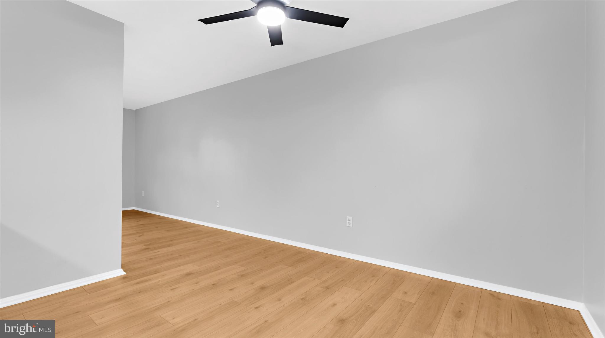 8009 Nolcrest Road Glen Burnie, MD 21061 - Photo 12 of 35 an empty room with a chandelier fan and windows