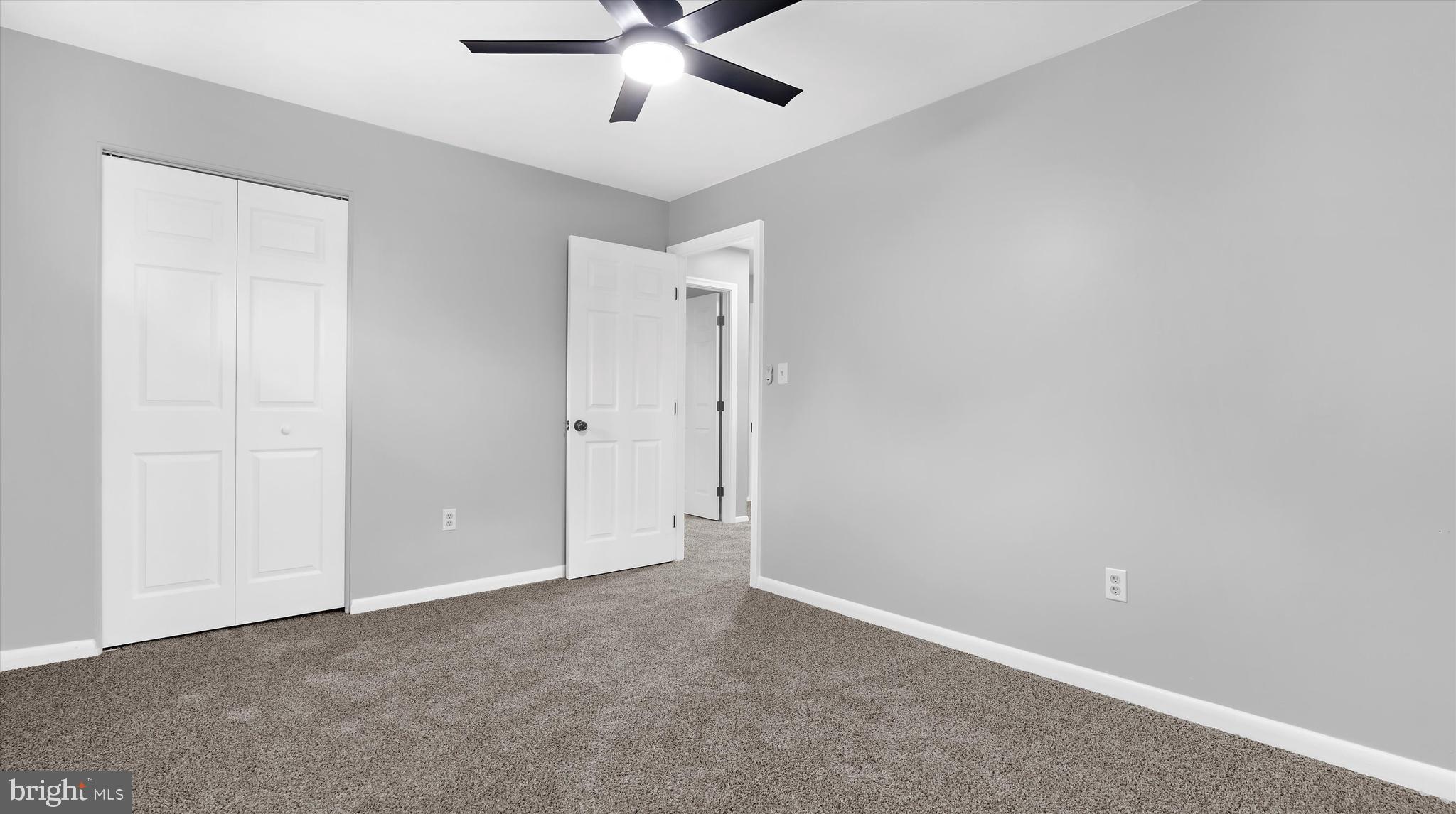 8009 Nolcrest Road Glen Burnie, MD 21061 - Photo 17 of 35 an empty room with closet and a chandelier fan