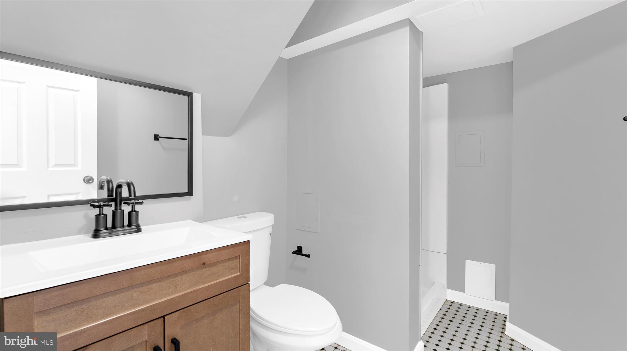 8009 Nolcrest Road Glen Burnie, MD 21061 - Photo 24 of 35 a bathroom with a sink a toilet and a mirror