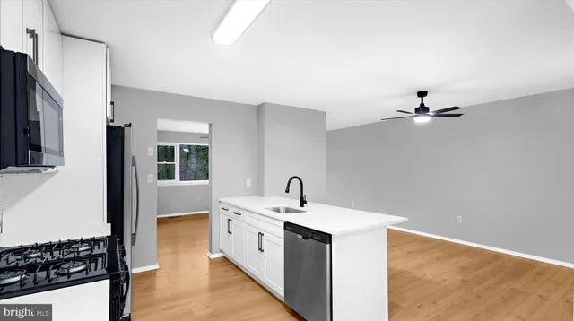 a kitchen with a sink appliances and cabinets