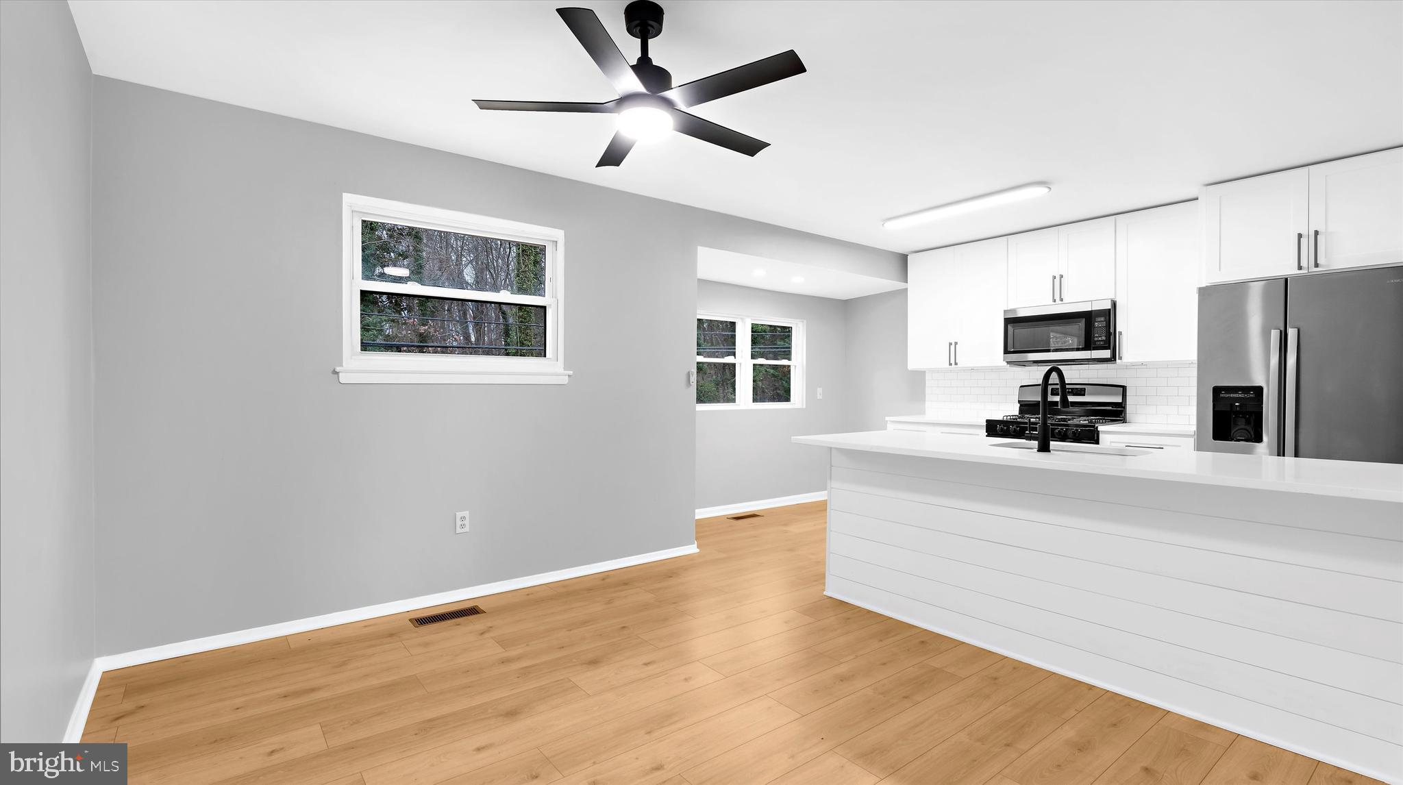 8009 Nolcrest Road Glen Burnie, MD 21061 - Photo 4 of 35 a living room with stainless steel appliances kitchen island sink and refrigerator