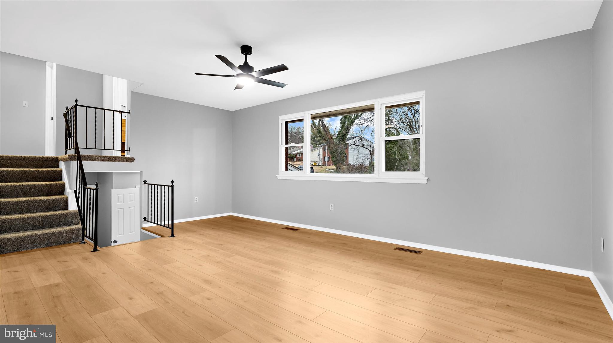 8009 Nolcrest Road Glen Burnie, MD 21061 - Photo 5 of 35 a view of empty room with wooden floor and fan