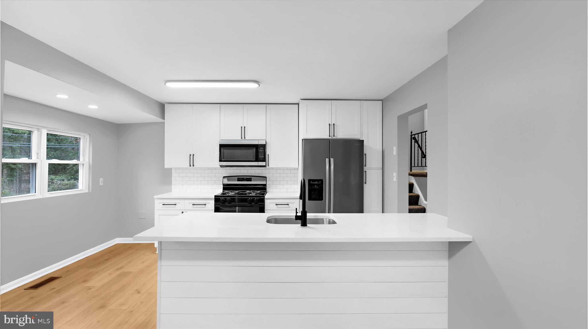 8009 Nolcrest Road Glen Burnie, MD 21061 - Photo 6 of 35 a kitchen with stainless steel appliances a refrigerator and microwave