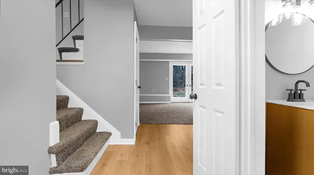 a view of entryway and hall with wooden floor
