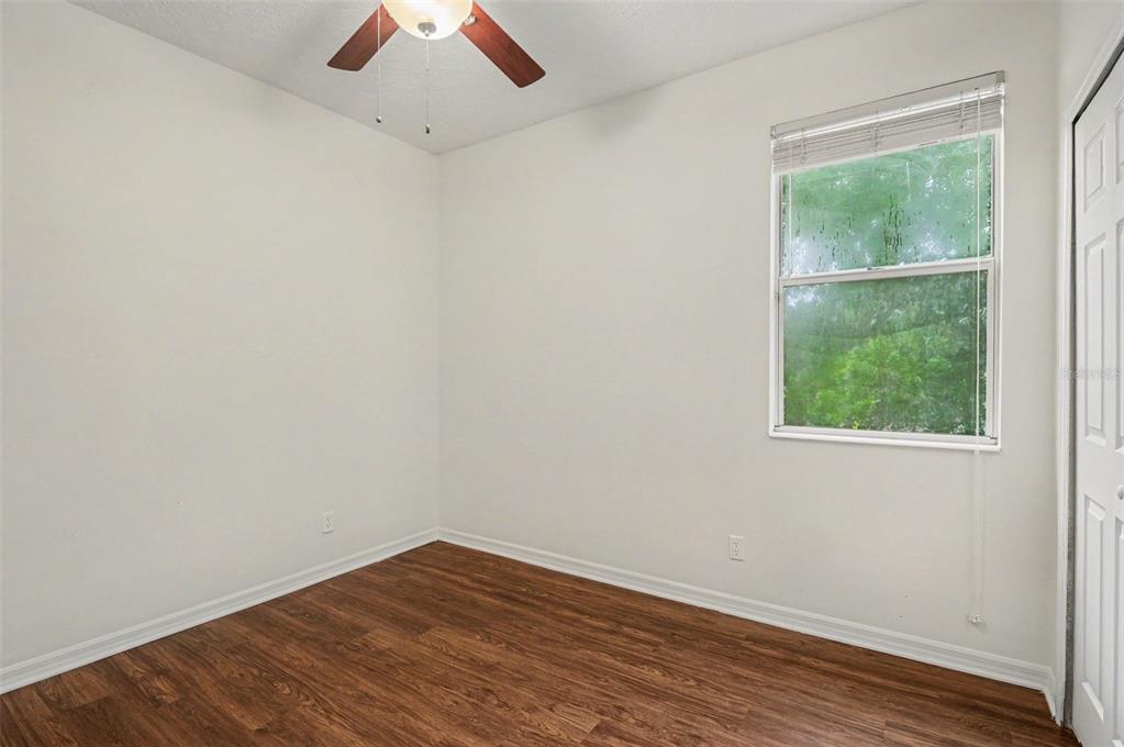 4819 Indian Deer Road Windermere, FL 34786 - Photo 18 of 30 an empty room with a window and wooden floor
