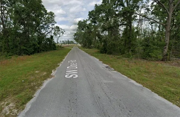 a view of a street with a yard