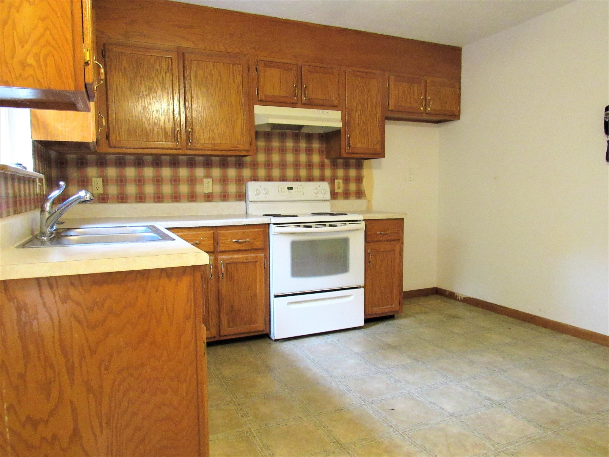 144 Ross Williams Road Lancing, TN 37770 - Photo 3 of 21 a kitchen with a stove sink and cabinets