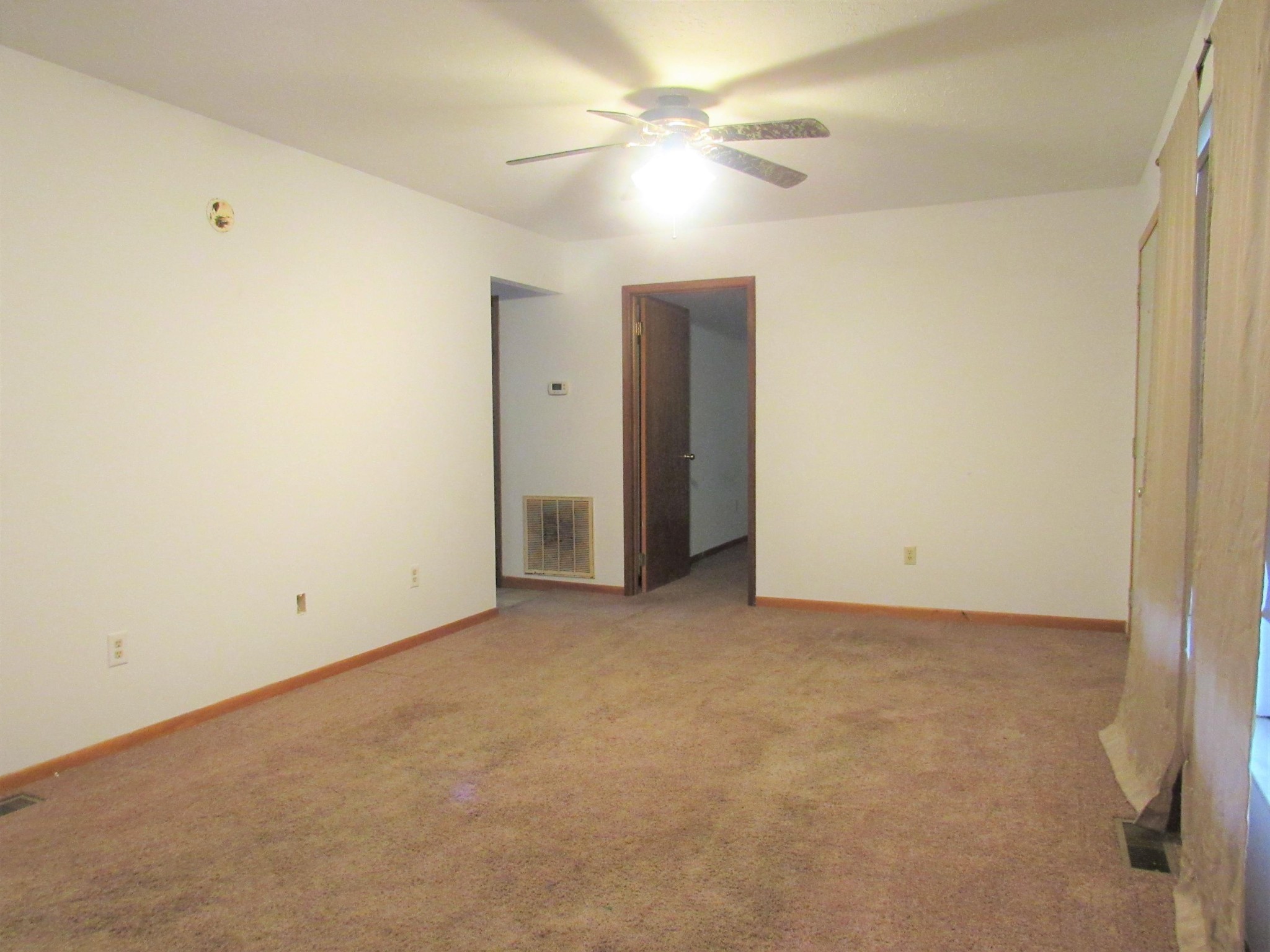 144 Ross Williams Road Lancing, TN 37770 - Photo 8 of 21 an empty room with a ceiling fan and a window