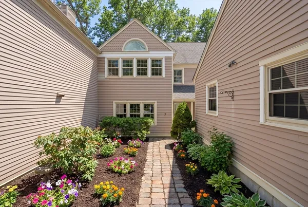 a kitchen with stainless steel appliances granite countertop a refrigerator a sink dishwasher a stove and white countertops with wooden floor