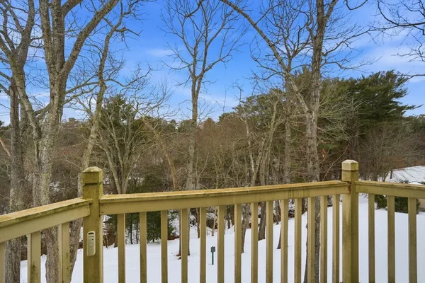 a view of a wooden fence and trees