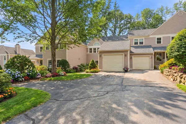 a kitchen with kitchen island granite countertop a sink cabinets and wooden floor