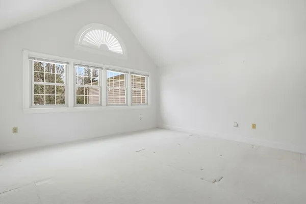 an empty room with a empty space and windows