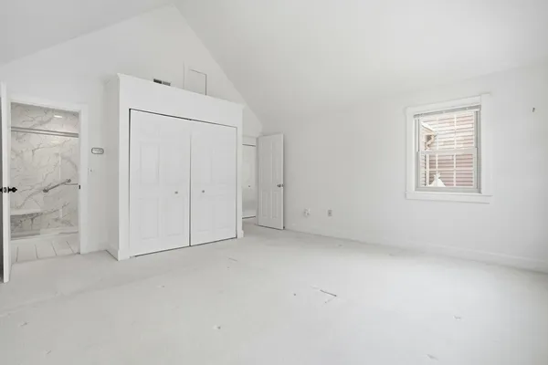 a bathroom with a granite countertop sink a toilet and a shower