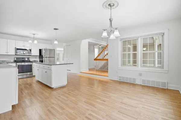 a view of kitchen with sink microwave refrigerator and cabinets