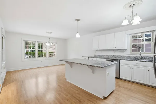 a kitchen with granite countertop a sink and a stove top oven