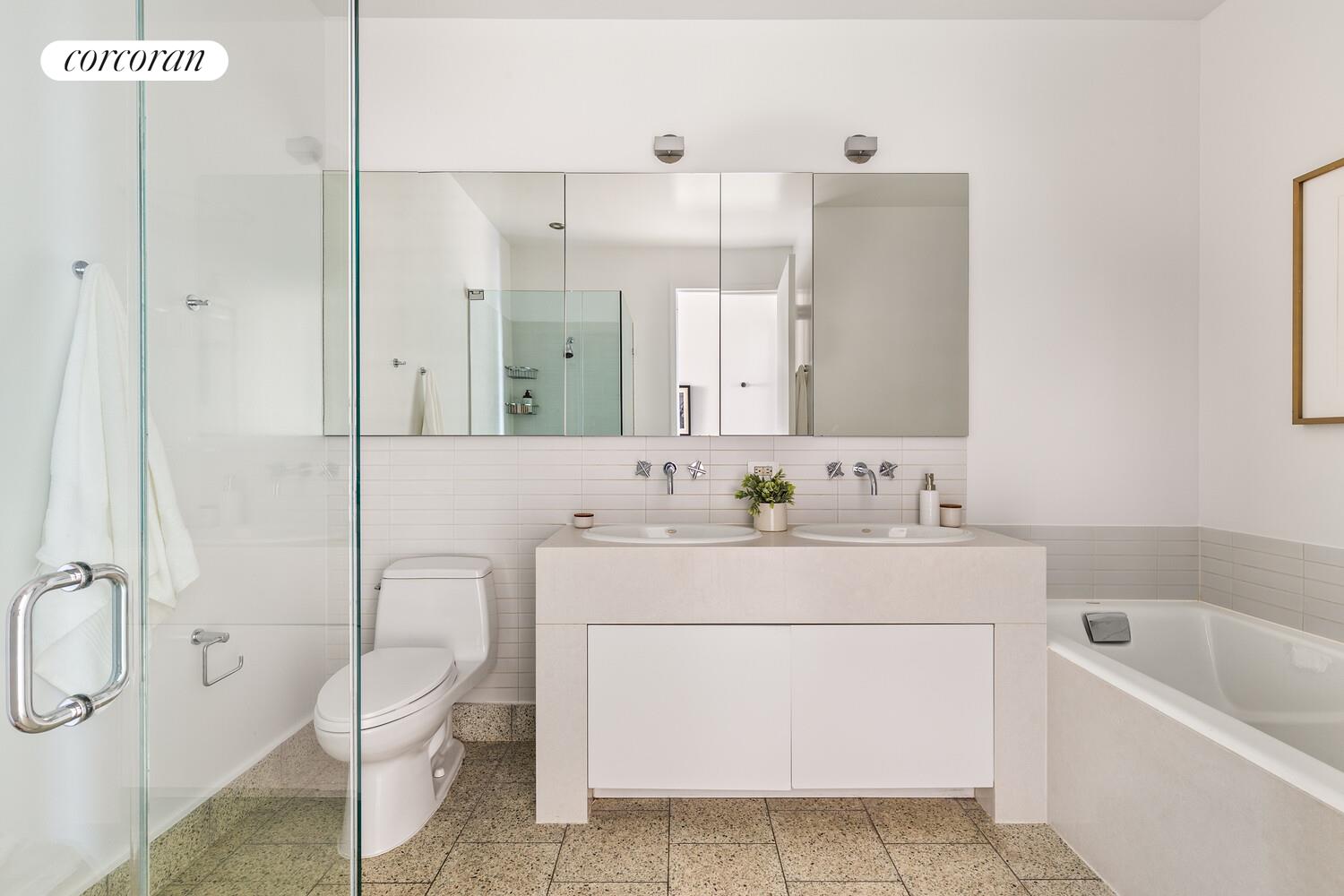 129 Lafayette Street, Unit 8C Manhattan, NY 10013 - Photo 6 of 11 a bathroom with a sink a toilet and shower