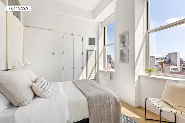 a bedroom with a bed and a chair