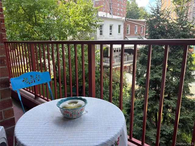 a view of a balcony with chair and wooden floor