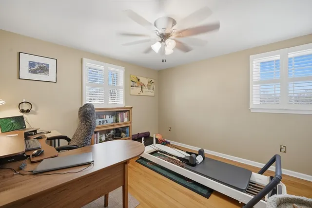 a room with gym equipment and a wooden floor