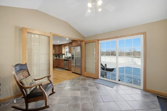 a living room with furniture and a floor to ceiling window