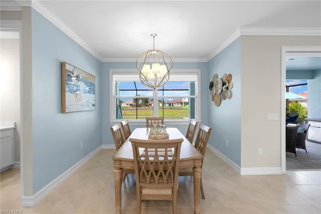 a dining room with furniture a window and a chandelier