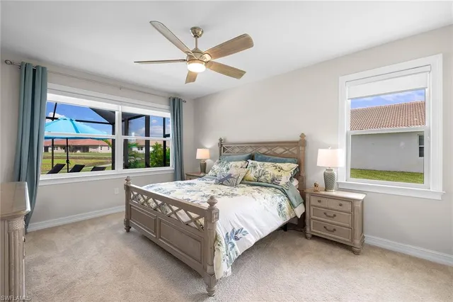 a bedroom with a bed and a large window