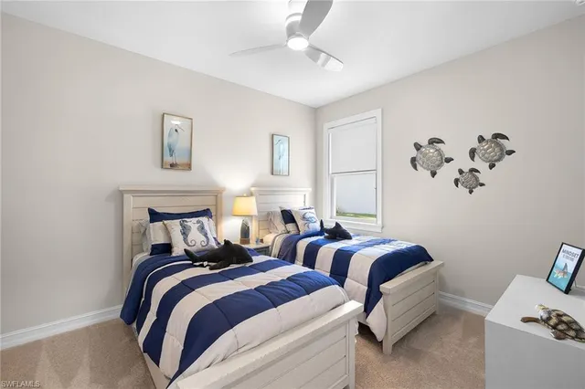 a bedroom with two beds and a chandelier