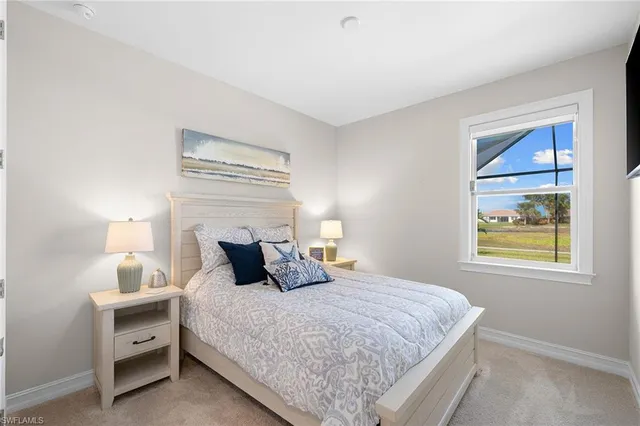 a bedroom with a bed and lamps