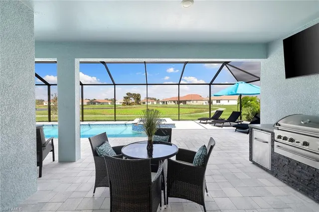 a dining room with furniture and a floor to ceiling window