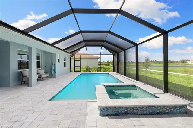 a view of a patio with a table and chairs under an umbrella