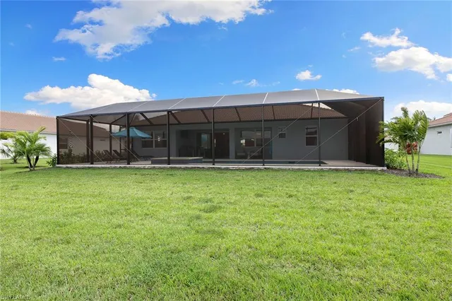 a front view of a house with a garden and yard