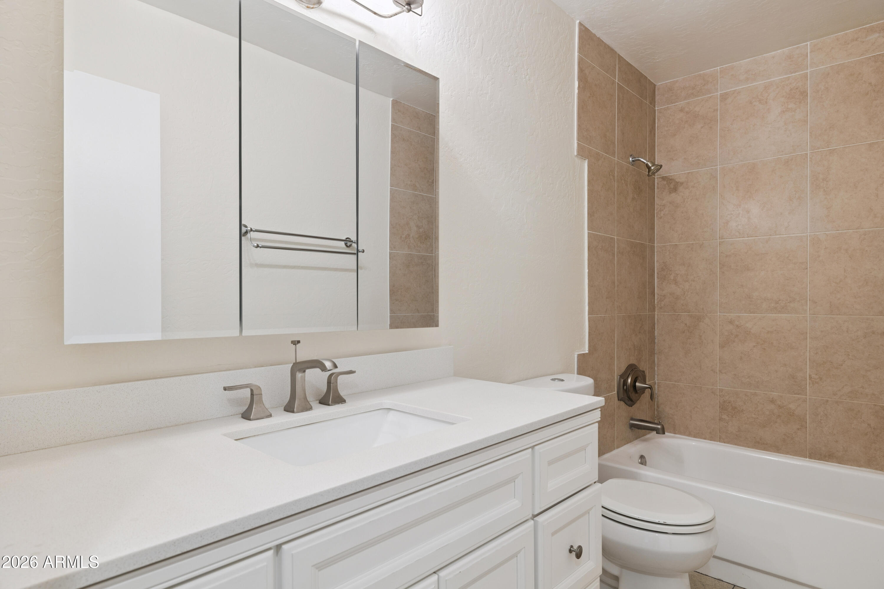 4343 East Osborn Road Phoenix, AZ 85018 - Photo 20 of 41 a bathroom with a sink a toilet and a mirror