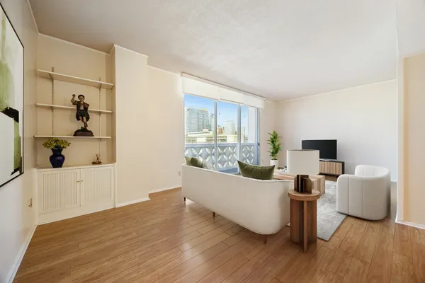 a living room with furniture and a wooden floor