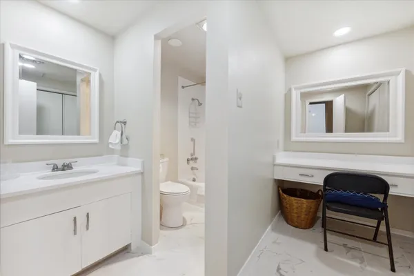 a spacious bathroom with a toilet sink and mirror