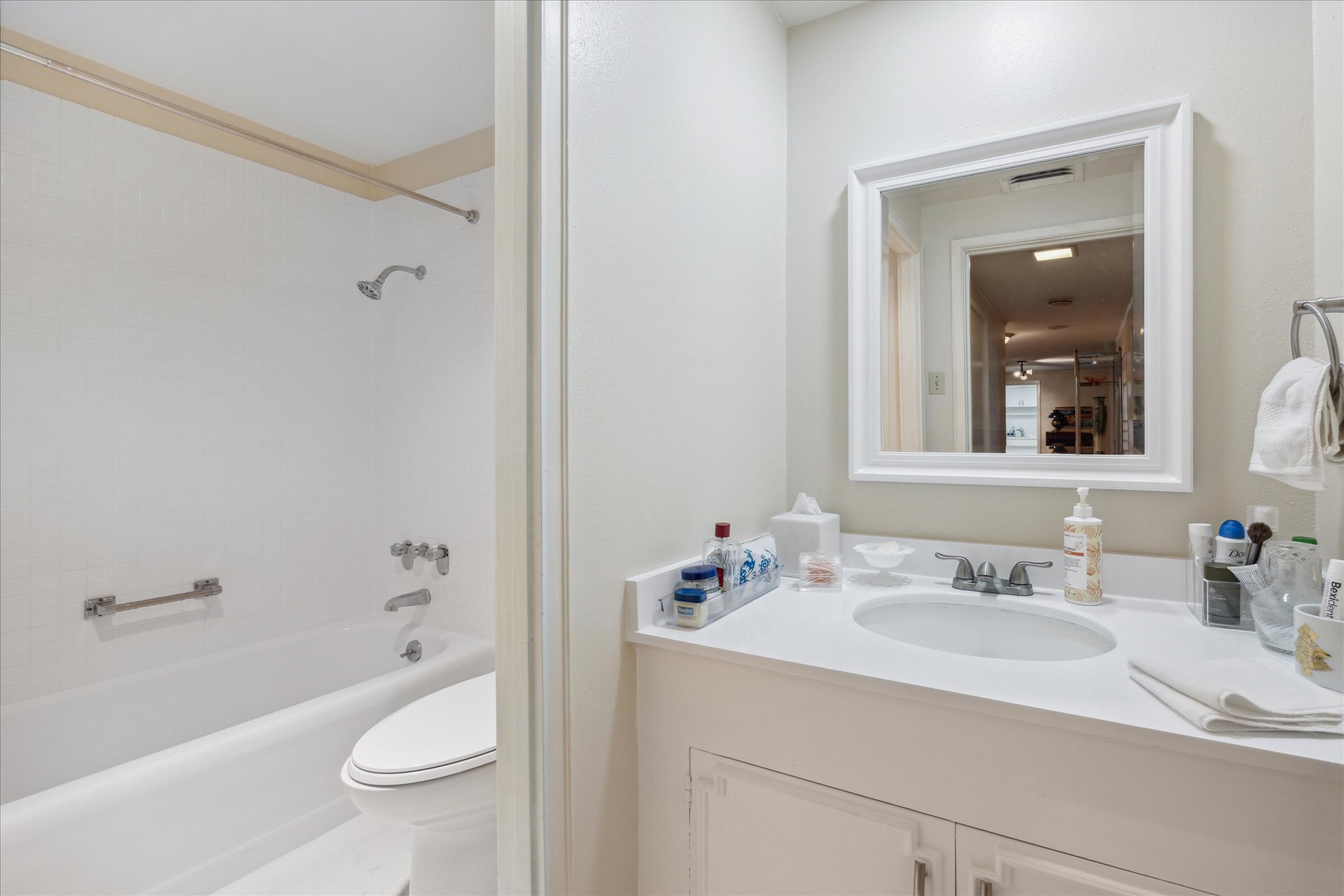 1801 Lavaca Street, Unit 7L Austin, TX 78701 - Photo 8 of 25 a bathroom with a granite countertop sink toilet and shower