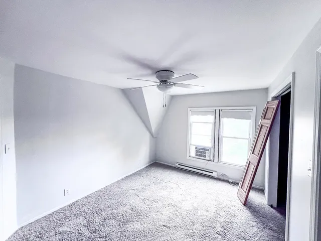 an empty room with windows and stairs