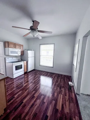 wooden floor in an empty room with a fireplace