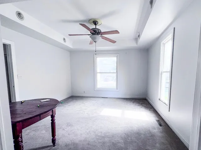 a view of room with a ceiling fan and window