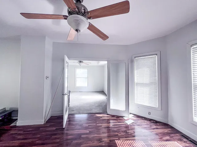a view of an empty room and wooden floor