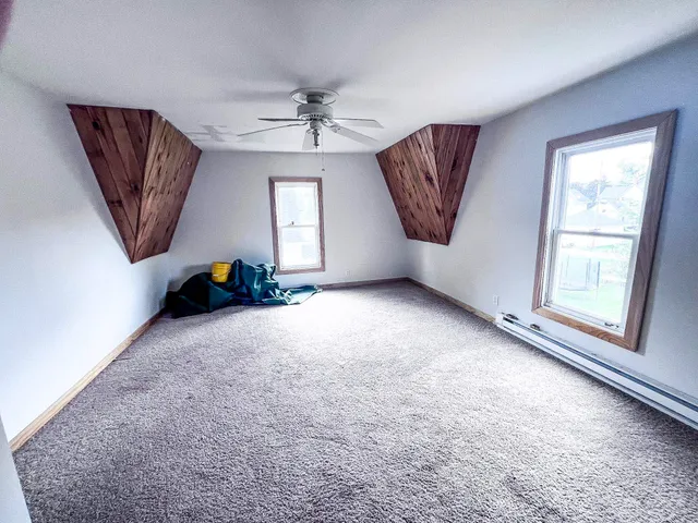 a view of a livingroom with a window and a ceiling fan